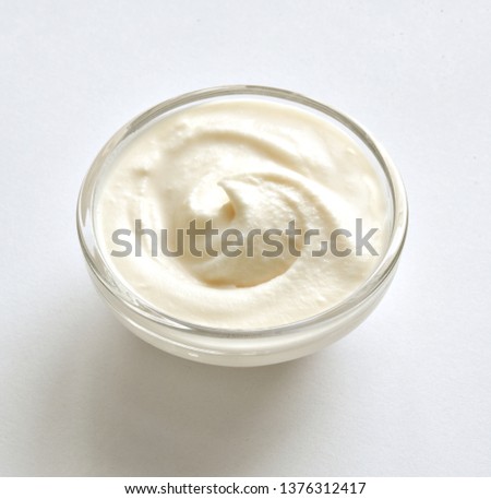 Curl of cream in a glass bowl