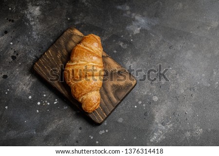 French croissant. Freshly baked croissants with jam on dark stone background. Tasty croissants with copy space Royalty-Free Stock Photo #1376314418