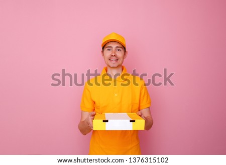 Photo of courier man with pizza box in hands .