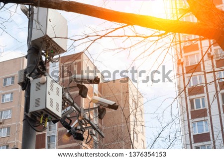Road and lane tracking cameras hang over the roadway. Against the backdrop of urban high-rise buildings