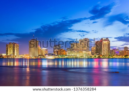 New Orleans, Louisiana, USA downtown city skyline on the Mississippi River at dusk.