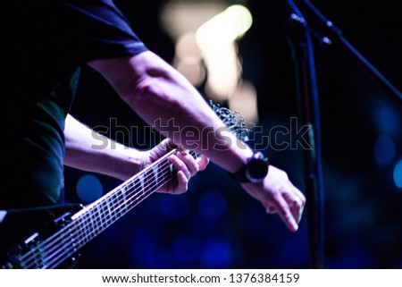 guitarist on stage during concert