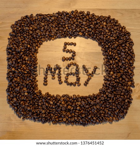 May 5, may calendar of coffee beans on wooden background