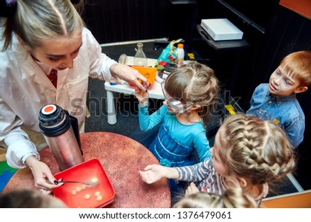Chemical show for kids. Professor carried out chemical experiments with liquid nitrogen on Birthday little girl.
