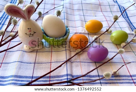 colorful Easter eggs with a sprig of willow on napkins