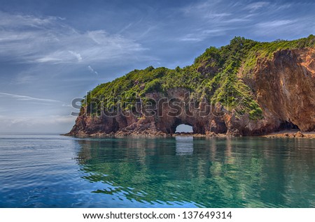 Image of tropical asian landscape with a cliff in water.