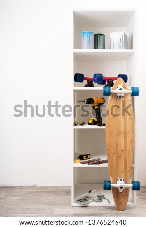 Mastrekskoy interior for mending skateboards and longborods. White cabinet with tools. Copy space