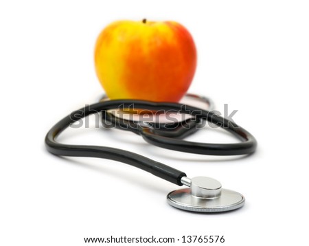 Medical stethoscope and apple isolated on white background