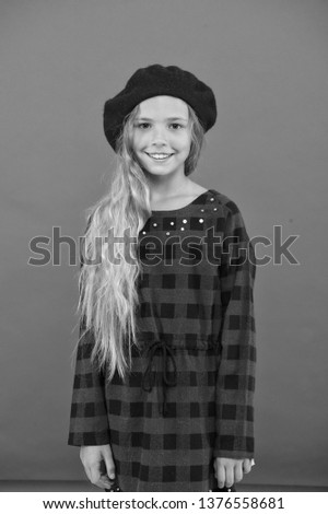 Kid little cute girl with long hair posing in hat red background. Fashionable beret accessory for female. How to wear french beret. Beret style inspiration. How to wear beret like fashion girl.