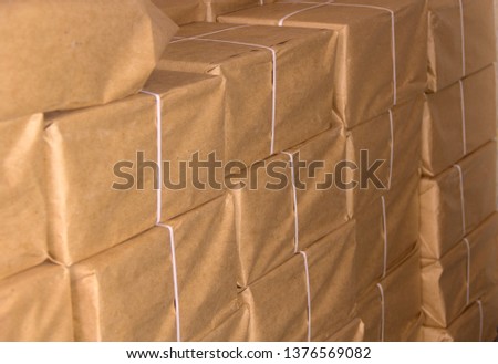 Packs of paper packed in gray paper and tied with white tape folded over the wall
