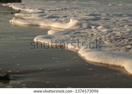 Seascape photography of foam at golden hour
