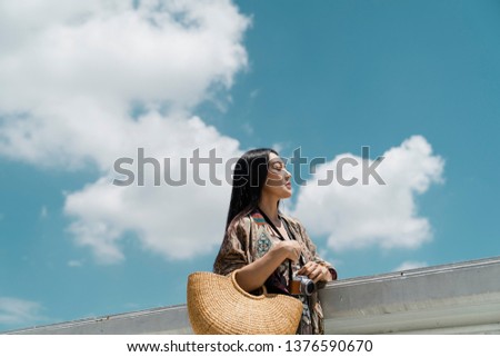 side view portrait of an elegant beautiful woman with fresh blue sky background.