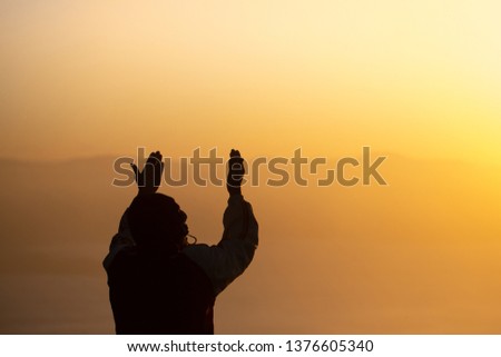 Young man praying in the morning, Hands folded in prayer concept for faith, spirituality and religion  Royalty-Free Stock Photo #1376605340
