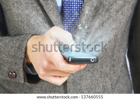 young adult type with the thumb on his smart phone that emits light