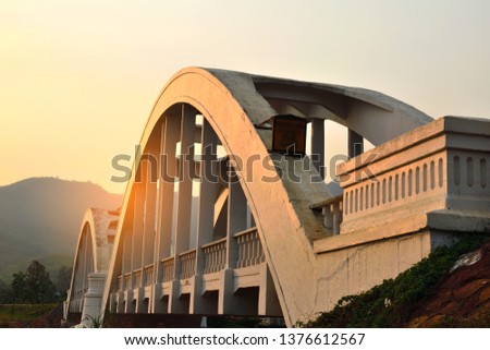 side view of grass,bridge and the evening sky