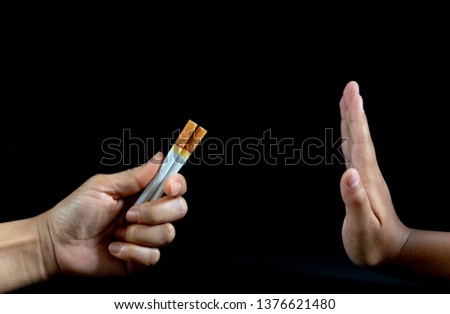 World No Tobacco Day, Say NO to STOP Smoking. Close up Man hand Reject cigarette offer on black background.