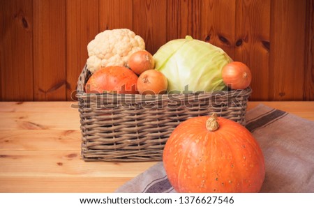 Fresh farm vegetables in wicker basket and near. Healthy eating and organic farming concept. 