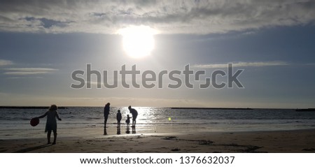 happy family at sea at sunset