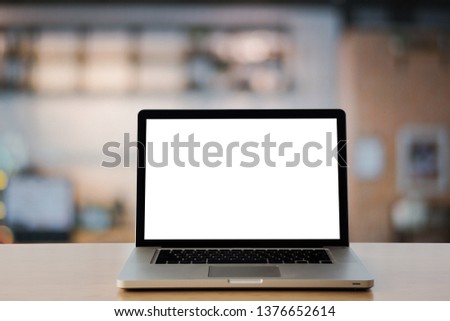 Empty space on wooden Desk with Laptop with blank white screen,at cafe  blurred background. - Image