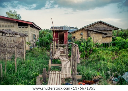 The background of a wooden house in the country (Myanmar village) where tourists can take pictures in public while traveling, surrounded by mountains,mangroves,trees,fresh air.