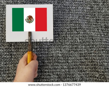 flag of mexico hand on gray background