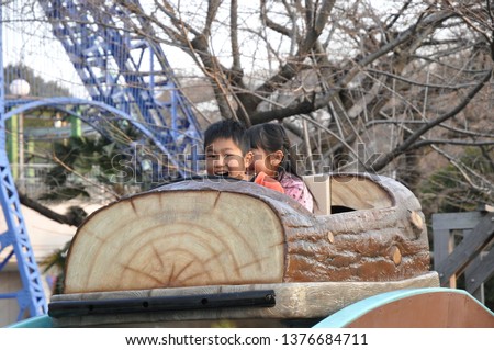 Asian little boy and girl enjoy at park