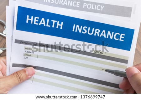 Health insurance form in man hand