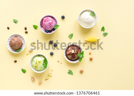 Ice Cream Assortment. Various fruit and berries ice creams on yellow background, copy space. Frozen yogurt or ice cream - healthy summer dessert.
