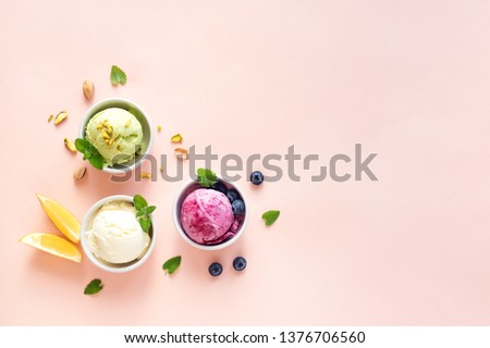 Ice Cream Assortment. Various fruit and berries ice creams on pink background, copy space. Frozen yogurt or ice cream - healthy summer dessert.