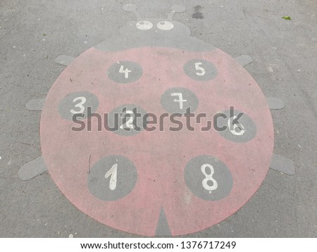 Drawings on Pavement - Picture of a Ladybug  on Asphalt - Playing with Numbers from One to Eight - Childhood - Learning Games For Kids