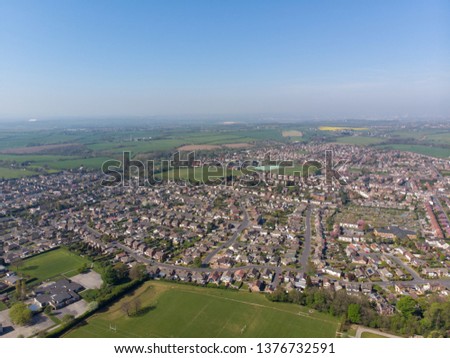 Aerial photo Garforth town centre a small town in Leeds West Yorkshire showing rows of houses.