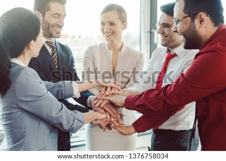 Diversity team of business people in kick-off meeting stacking hands together  Royalty-Free Stock Photo #1376758034