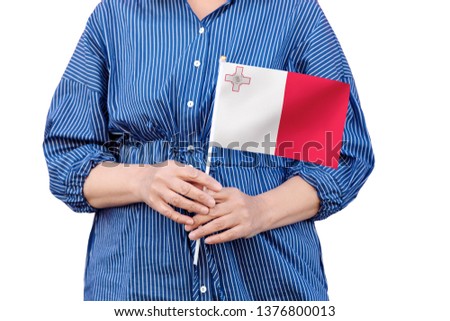 Malta flag. Close up of woman's hands holding a national flag of Malta isolated on white background.
