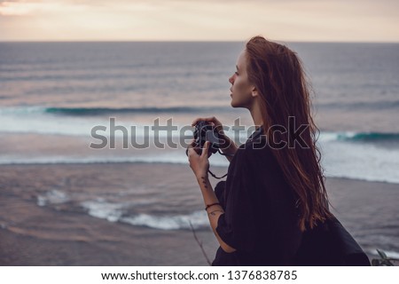 Laughing portrait of trendy and stylish woman make picture and look at camera,summer bright portrait of natural beauty.Smiling and happy woman look at camera,travel photo,summer accessories,jewelry