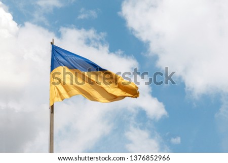 flag of Ukraine. Blue and yellow Ukrainian national flags on a flagpoles against a blue sky, bottom view. The symbol of 2019 ballot and poll in Ukraine, space for text