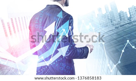 Businessman with documents over abstract city background with growing graphs and HUD interface. Stock market analysis concept. Toned image double exposure