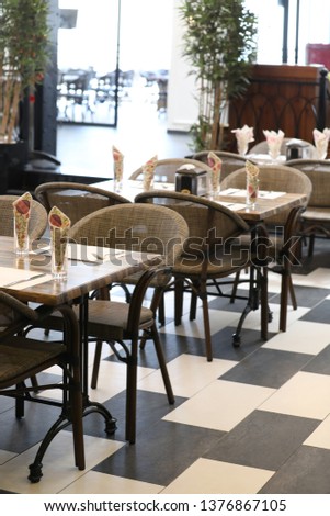 Picture chairs and wooden tables inside restaurant
