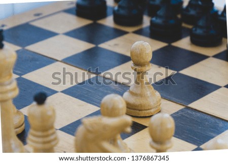 black and white chess pieces on a checkered board. the beginning of the game of chess