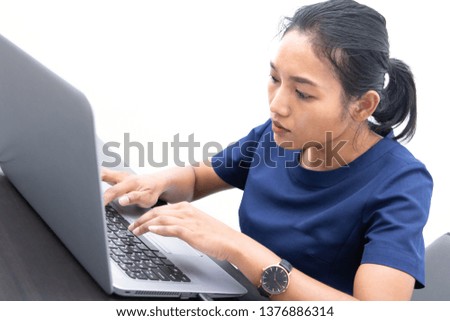 A young busy woman is looking at a laptop. Business woman working in office with computer.