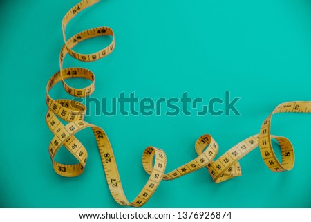 yellow centimeter on a blue background, spiral, diet, weight loss, with copy space for text