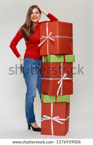 Full length portrait of happy woman with big heap of gift boxes.