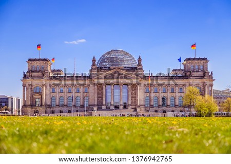 Picture of the Reichstag in Berlin in Springtime, green grass and flowers 