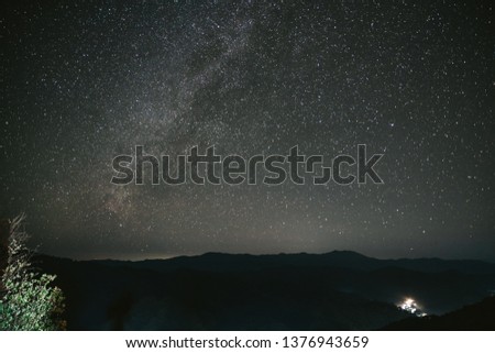 Night sky with bright stars in the Akha village of Maejantai on the hill in Chiang Mai, Thailand.