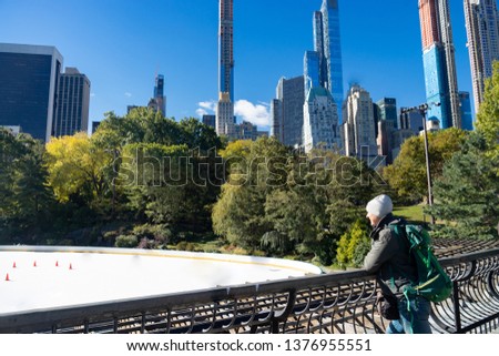 Man looking at empty Ice Rink at Central Park in winter