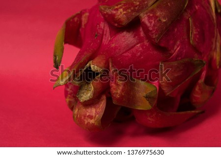 Exotic dragonfruit on a red background.