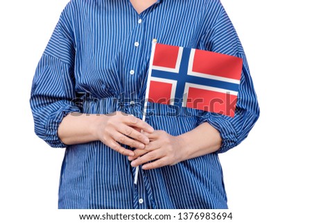 Norway flag. Close up of woman's hands holding a national flag of Norway isolated on white background.