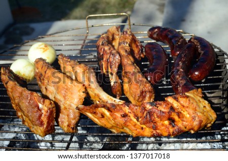 grilled sleepy pork ribs and sausages, close up view