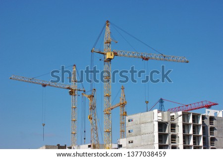 modern construction of multi-storey and apartment buildings. concrete structures for people's lives in the city. build houses. houses without Windows. cranes cargo to height for workers. technical