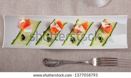 Picture of delicious salmon salad with two types of cheese and fresh cucumber