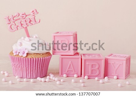 Cupcake with a cake pick and baby cubes Royalty-Free Stock Photo #137707007